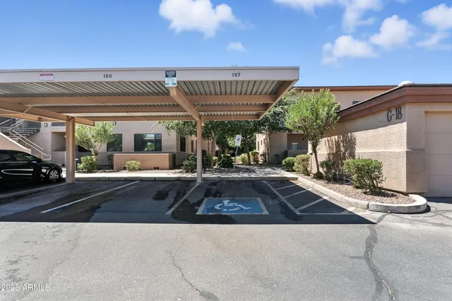 a front view of a house with a garden and a tree