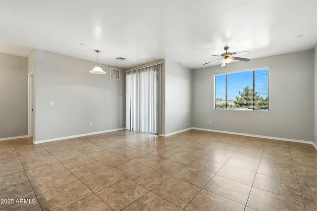 a view of kitchen with refrigerator and window