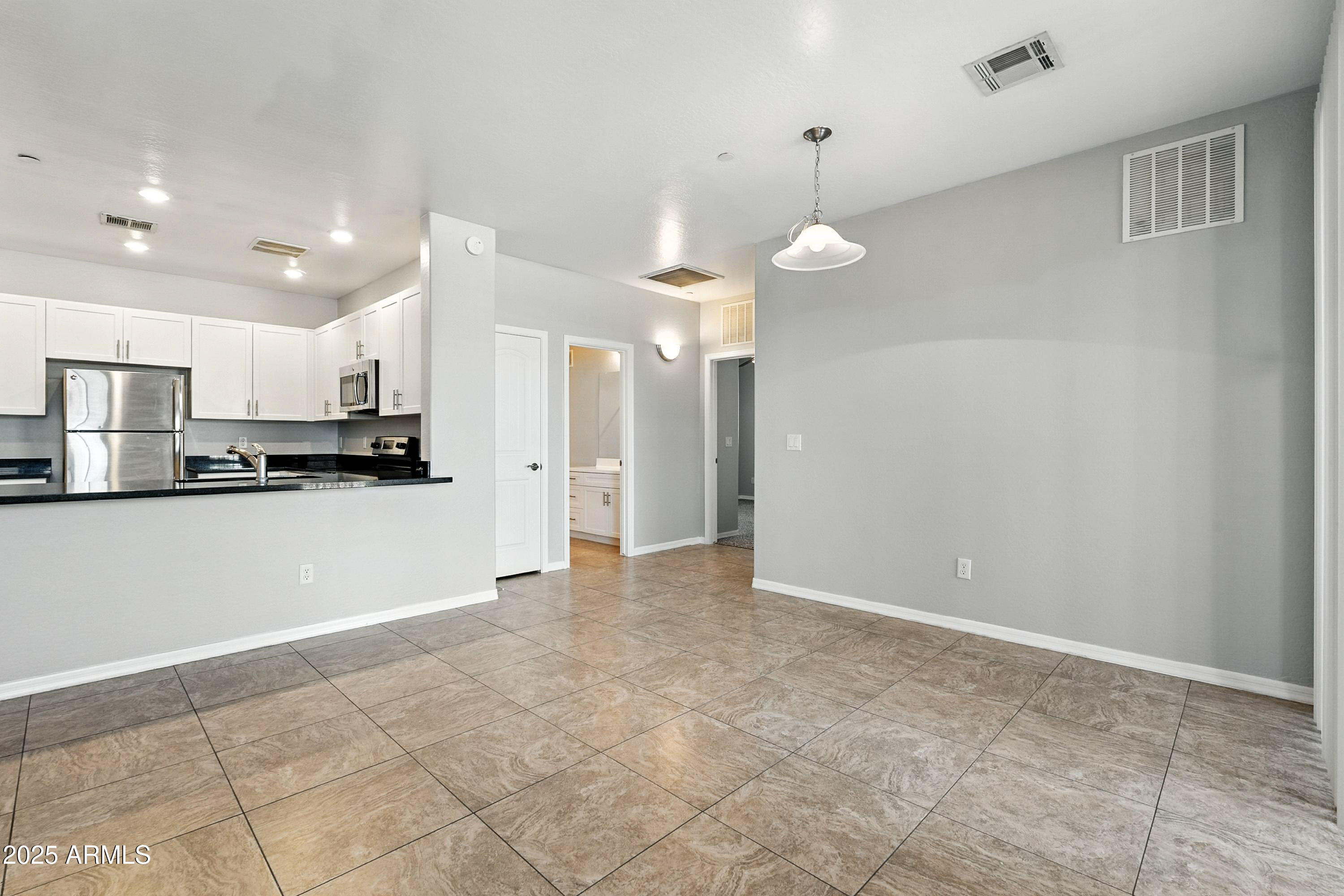 3330 South Gilbert Road, Unit 2062 Chandler, AZ 85286 - Photo 7 of 61 a view of a kitchen with an empty space and wooden floor