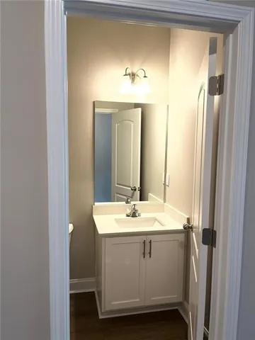 an empty room with wooden floor and cabinet