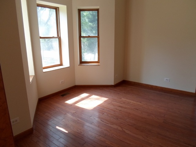 1530 Riverside Avenue St. Charles, IL 60174 - Photo 3 of 10 an empty room with wooden floor and windows