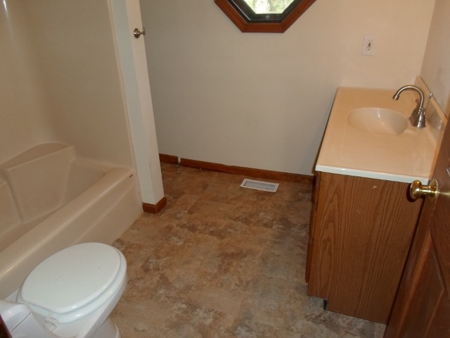 1530 Riverside Avenue St. Charles, IL 60174 - Photo 9 of 10 a bathroom with a granite countertop sink toilet and bathtub