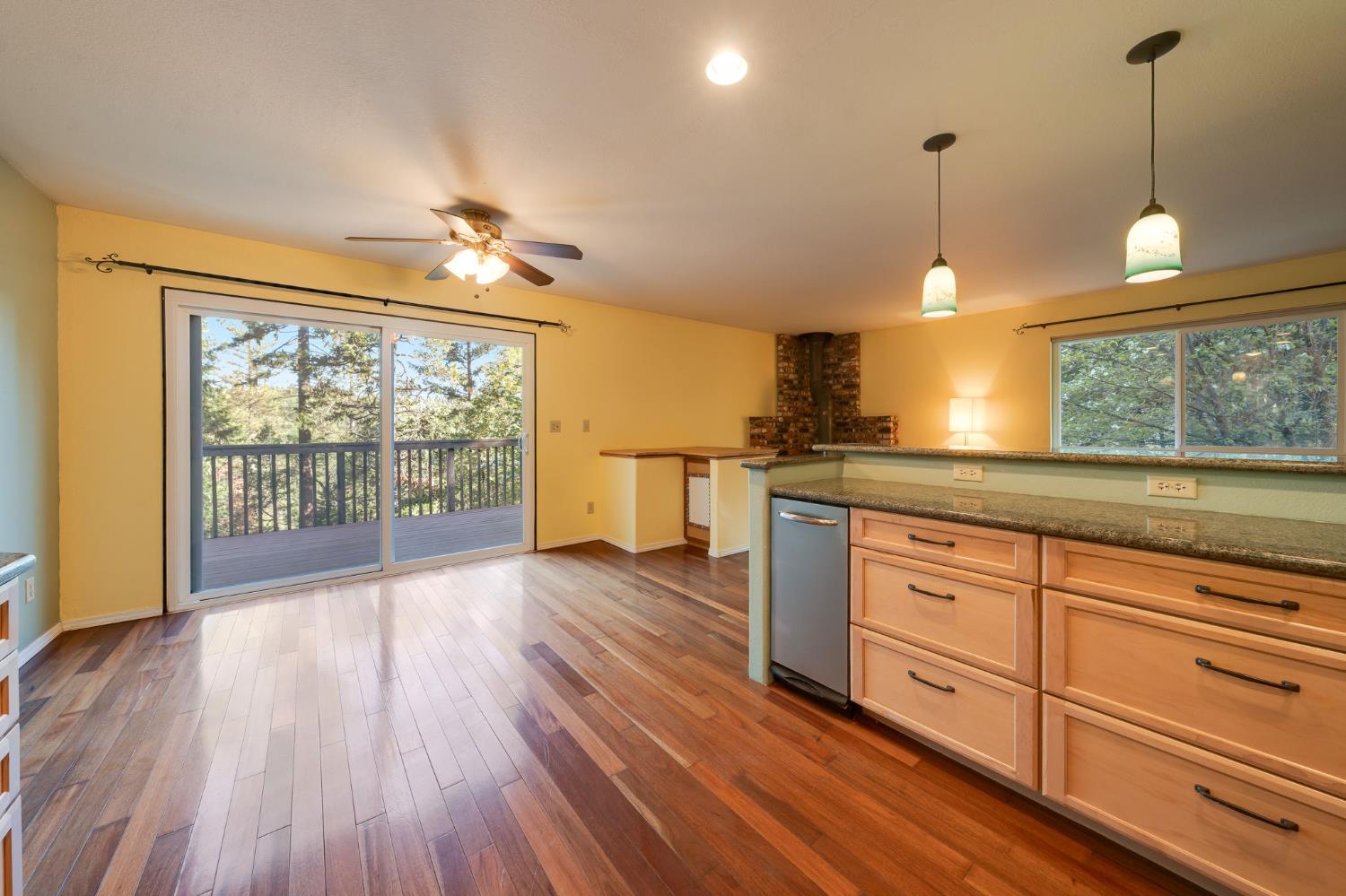6139 Shad Way Pollock Pines, CA 95726 - Photo 13 of 49 a open kitchen with granite countertop a stove a sink and wooden floors