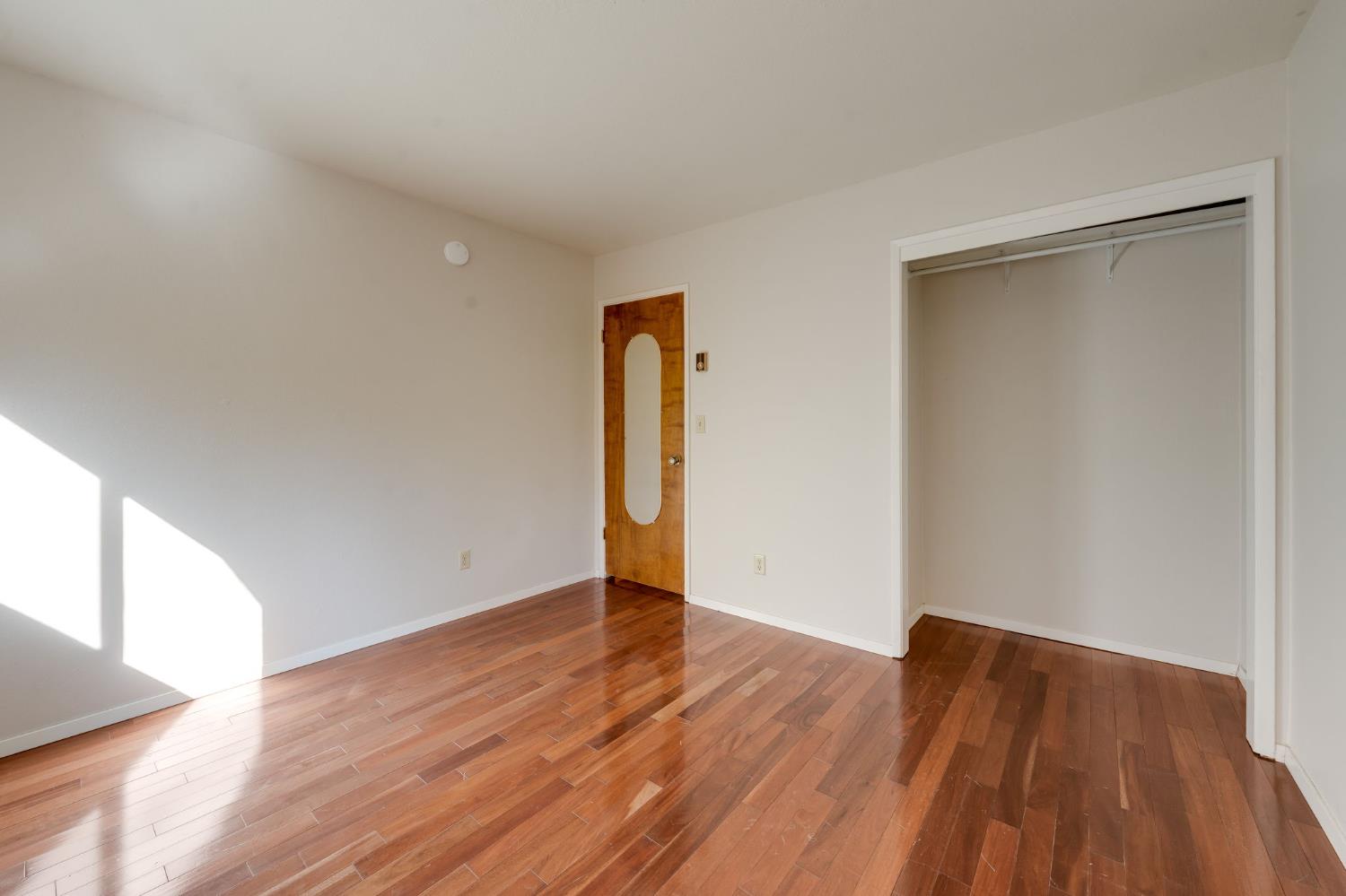 6139 Shad Way Pollock Pines, CA 95726 - Photo 19 of 49 a view of an empty room with wooden floor and a window
