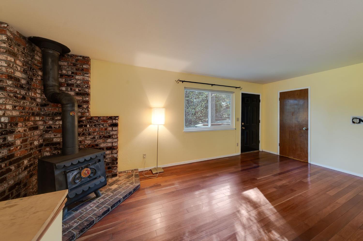 6139 Shad Way Pollock Pines, CA 95726 - Photo 4 of 49 a view of an empty room with window and wooden floor