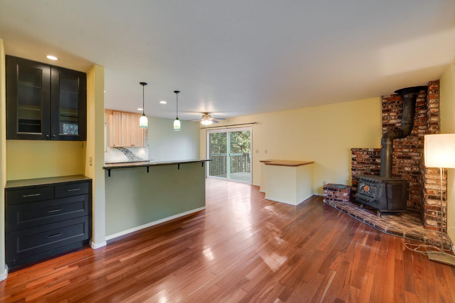 6139 Shad Way Pollock Pines, CA 95726 - Photo 5 of 49 a view of a kitchen with kitchen island a sink wooden floor and a large window