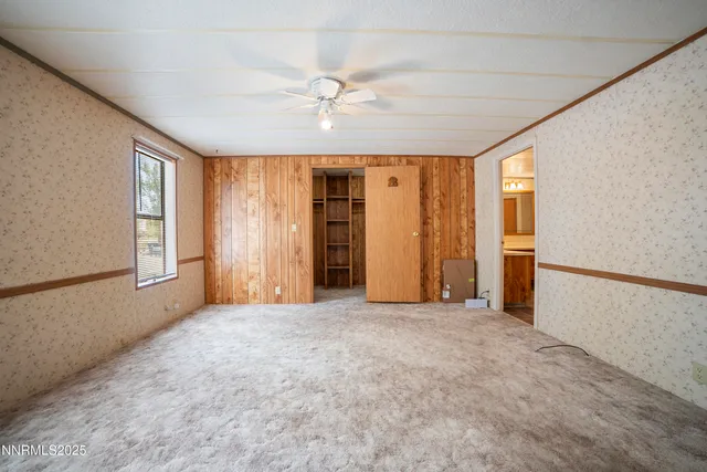 a view of empty room with window and refrigerator
