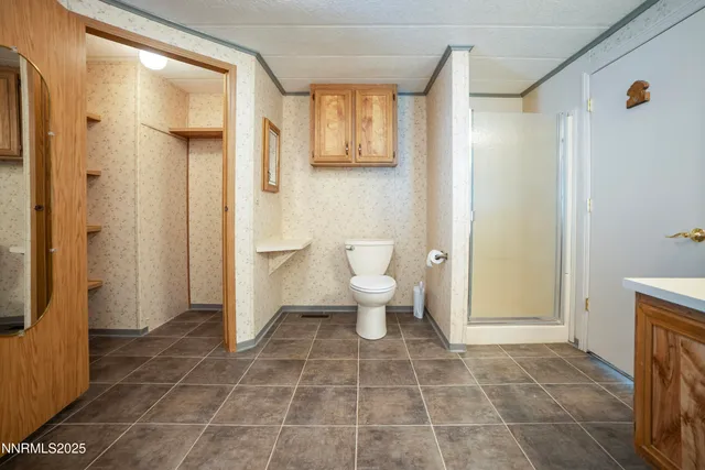 a bathroom with a toilet and a shower