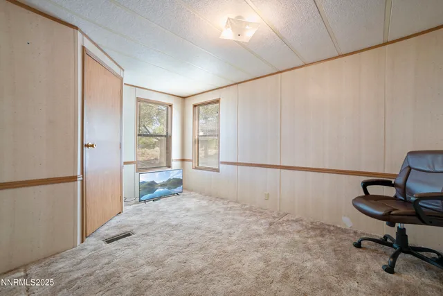 a bedroom with a bed and a chair