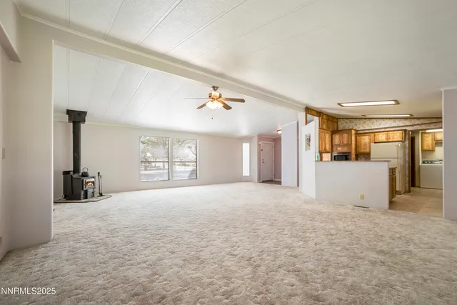 a view of a livingroom with wooden floor and a window