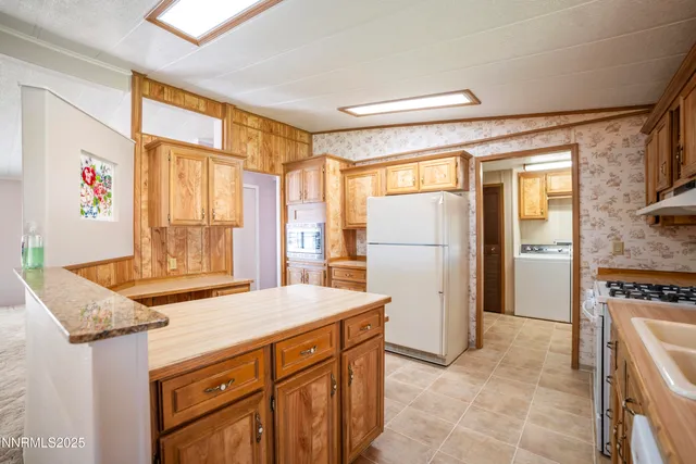 a kitchen with stainless steel appliances granite countertop a refrigerator and a stove