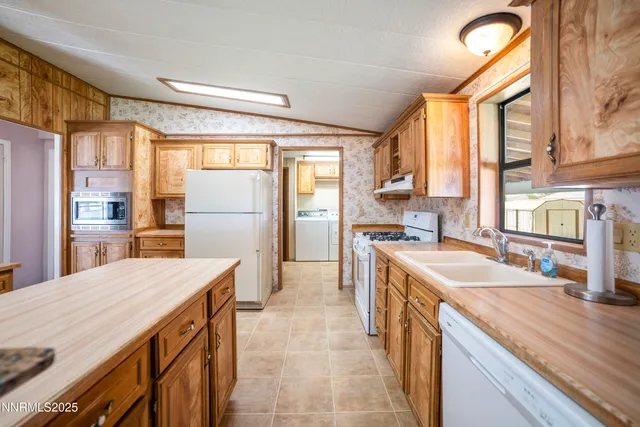 a kitchen with a stove a sink and a refrigerator