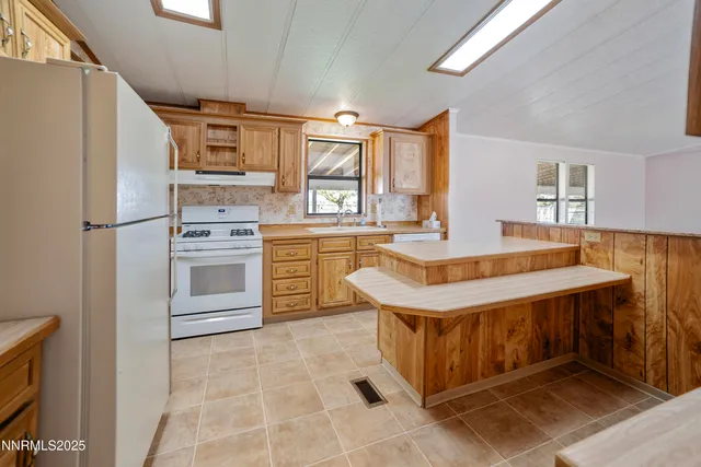 a kitchen with stainless steel appliances granite countertop a sink counter space and cabinets