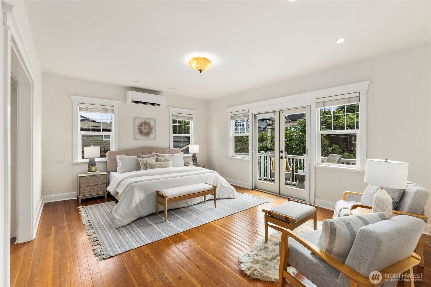 2446 Queen Anne Avenue North Seattle, WA 98109 - Photo 16 of 40 a spacious bedroom with a bed and a couch