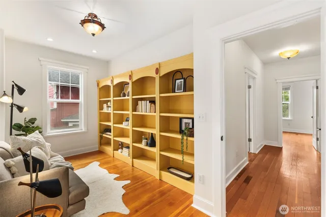 a view of a livingroom with workspace and a window