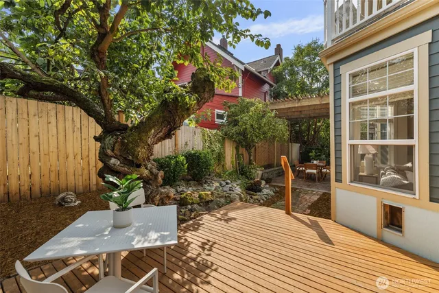 a view of a house with backyard and sitting area