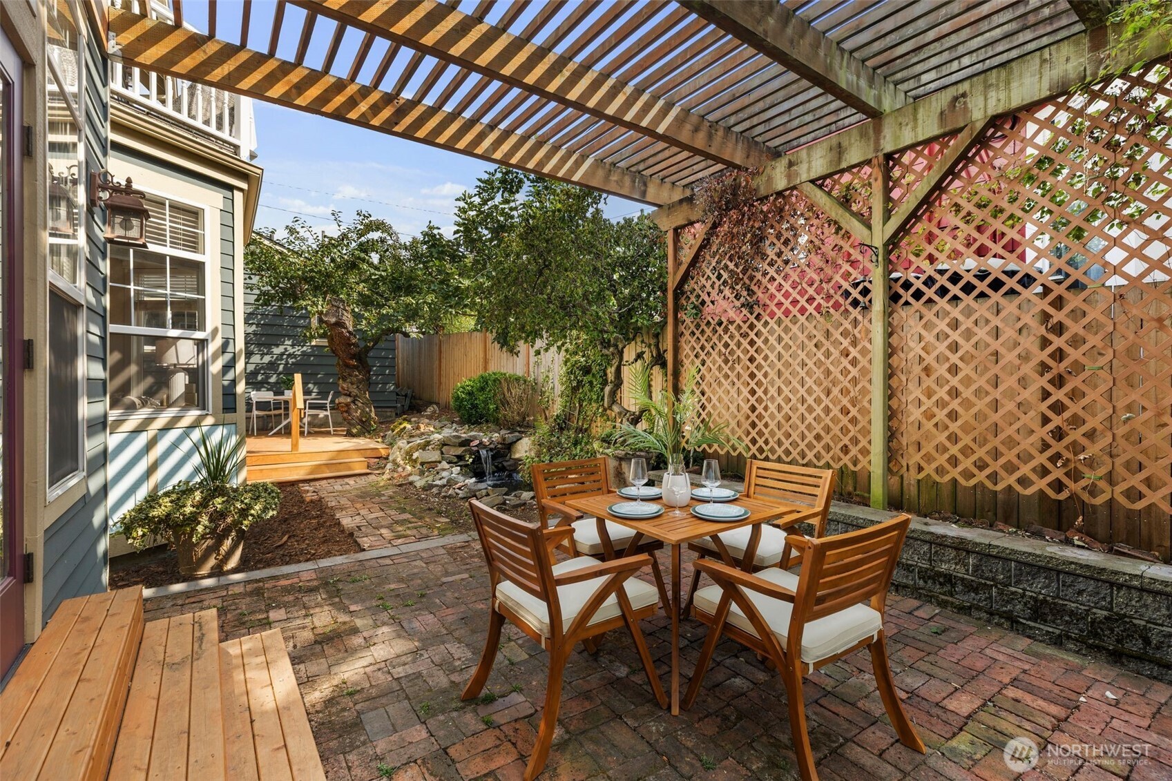 2446 Queen Anne Avenue North Seattle, WA 98109 - Photo 31 of 40 a view of patio with table and chairs and potted plants