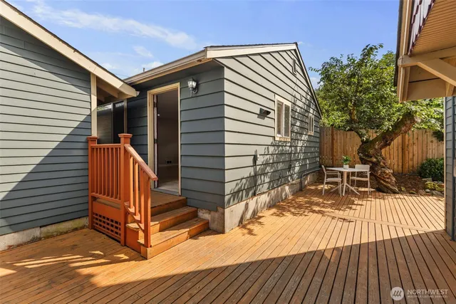 a view of outdoor space with deck and white furniture