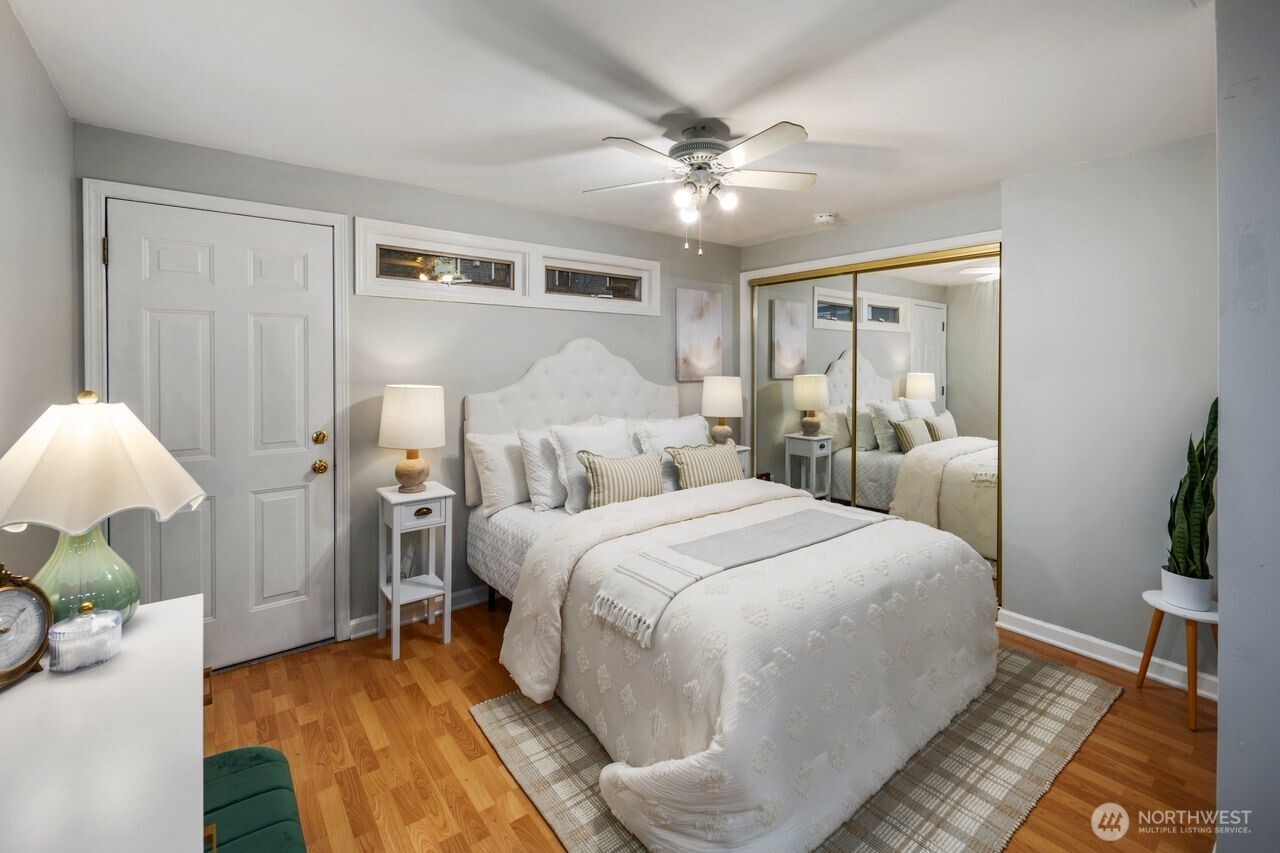 2446 Queen Anne Avenue North Seattle, WA 98109 - Photo 35 of 40 a bedroom with a bed and a chandelier