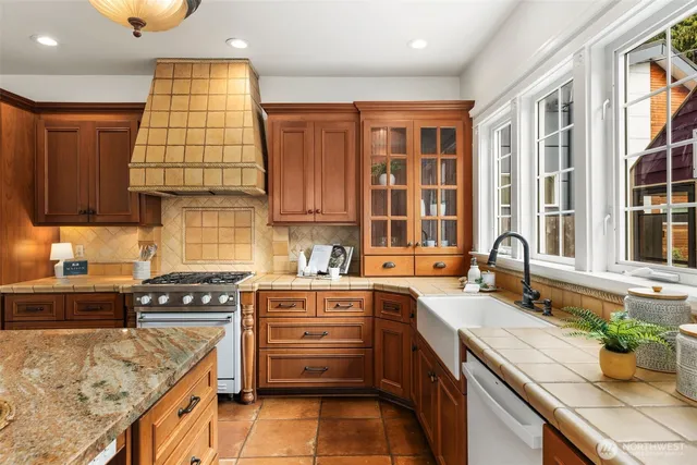 a kitchen with a sink stove and cabinets