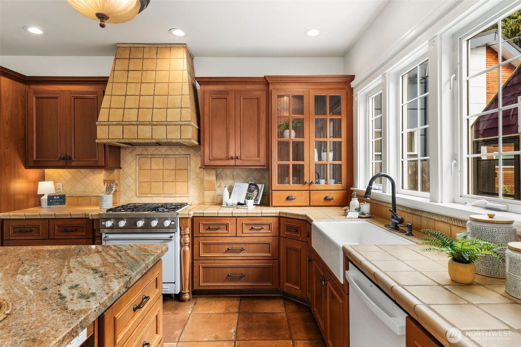 2446 Queen Anne Avenue North Seattle, WA 98109 - Photo 8 of 40 a kitchen with a sink stove and cabinets