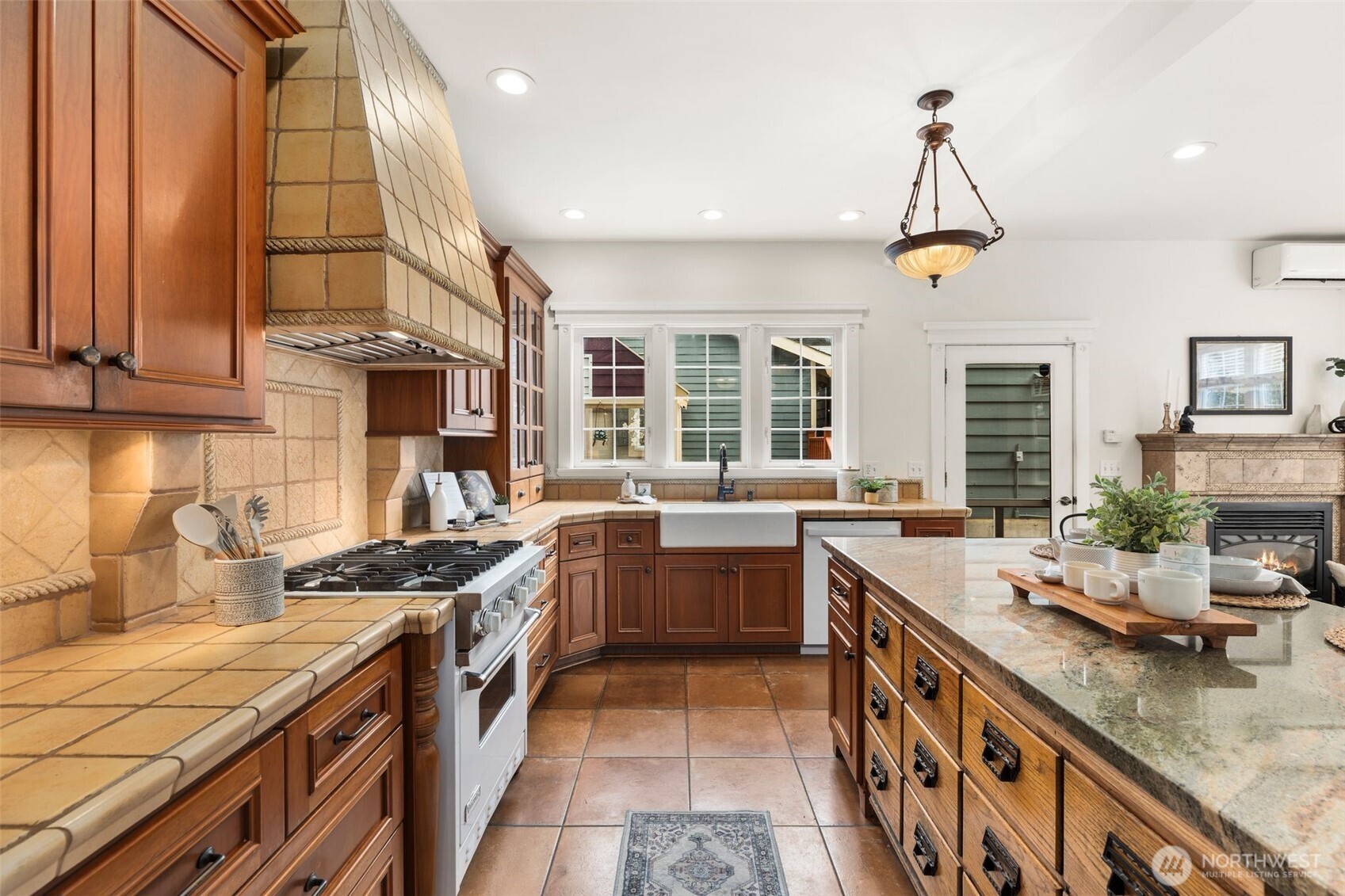2446 Queen Anne Avenue North Seattle, WA 98109 - Photo 10 of 40 a kitchen with stainless steel appliances granite countertop a sink a stove and a wooden cabinets