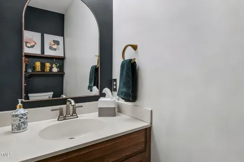 a bathroom with a tub a sink and a window