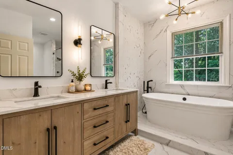 a bathroom with a double vanity sink mirror and