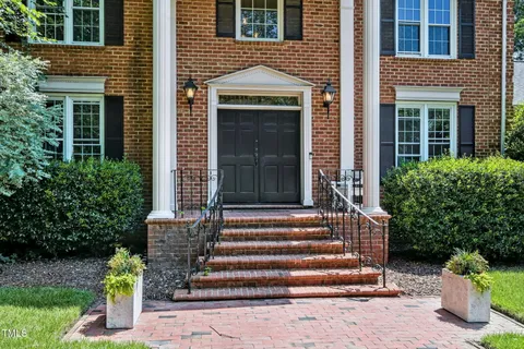 a front view of a house with plants