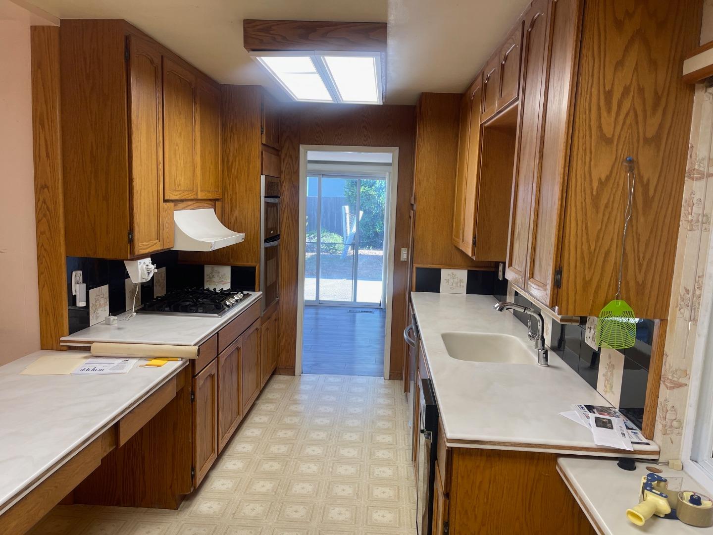 580 Cascade Drive Sunnyvale, CA 94087 - Photo 11 of 12 a large kitchen with kitchen island granite countertop a sink and a stove
