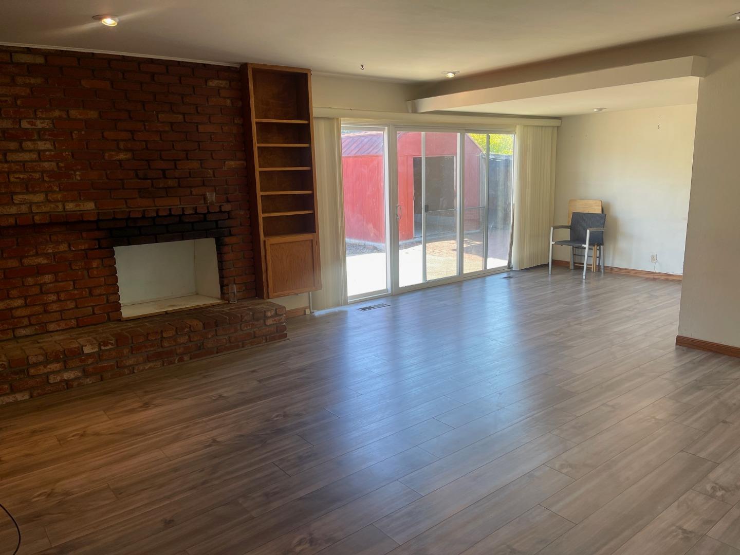 580 Cascade Drive Sunnyvale, CA 94087 - Photo 5 of 12 a view of an empty room with wooden floor and a window