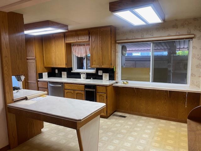 580 Cascade Drive Sunnyvale, CA 94087 - Photo 8 of 12 a kitchen with a sink a counter top space a stove and a window