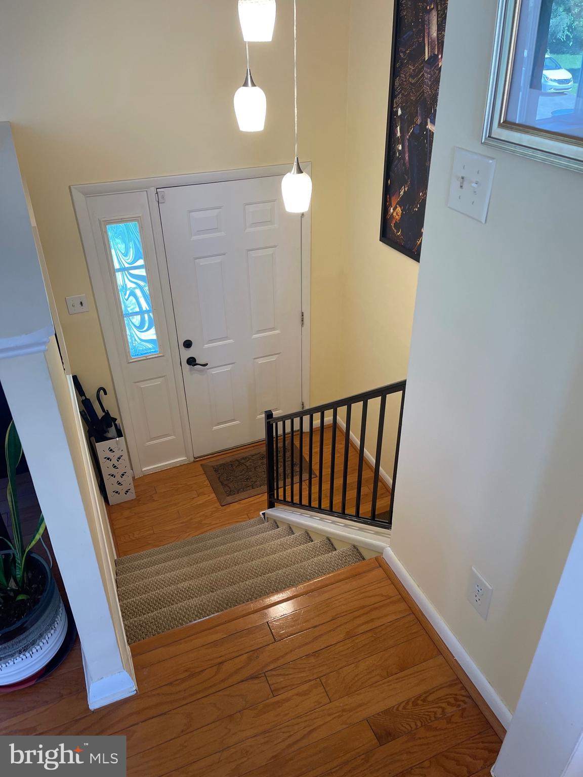 99 Exeter Court Shepherdstown, WV 25443 - Photo 20 of 51 a view of a hallway with wooden floor and stairs