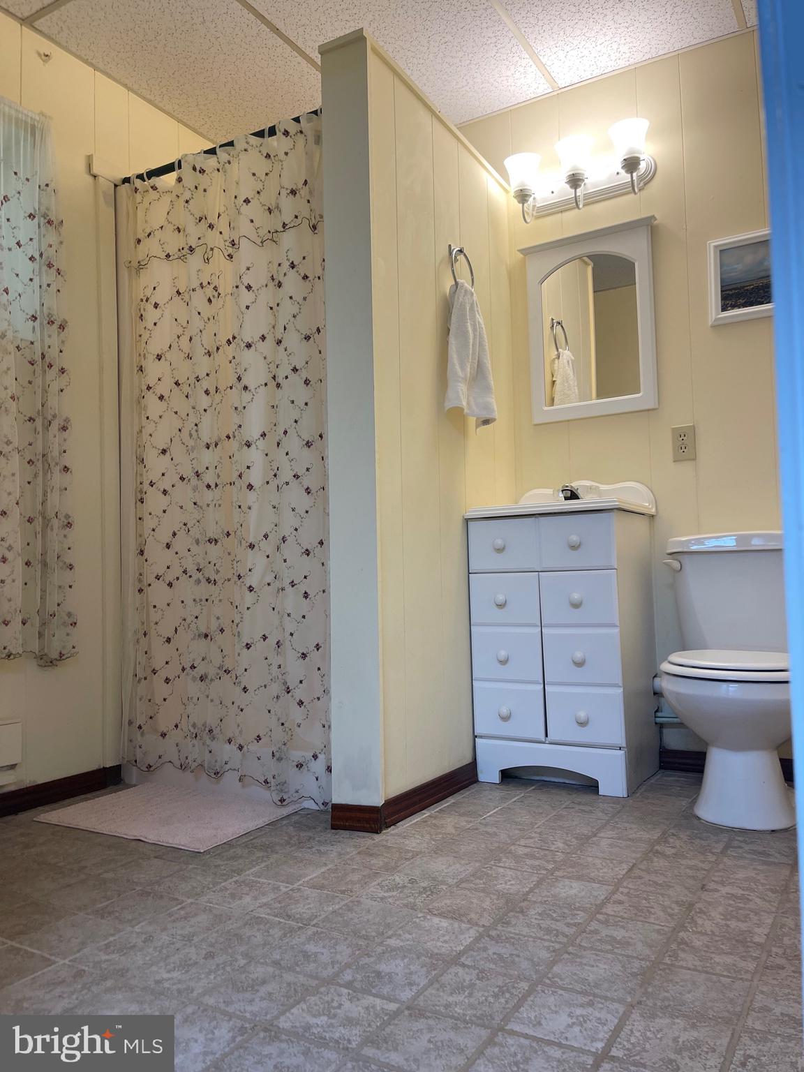 99 Exeter Court Shepherdstown, WV 25443 - Photo 31 of 51 a bathroom with a granite countertop toilet a sink and a mirror