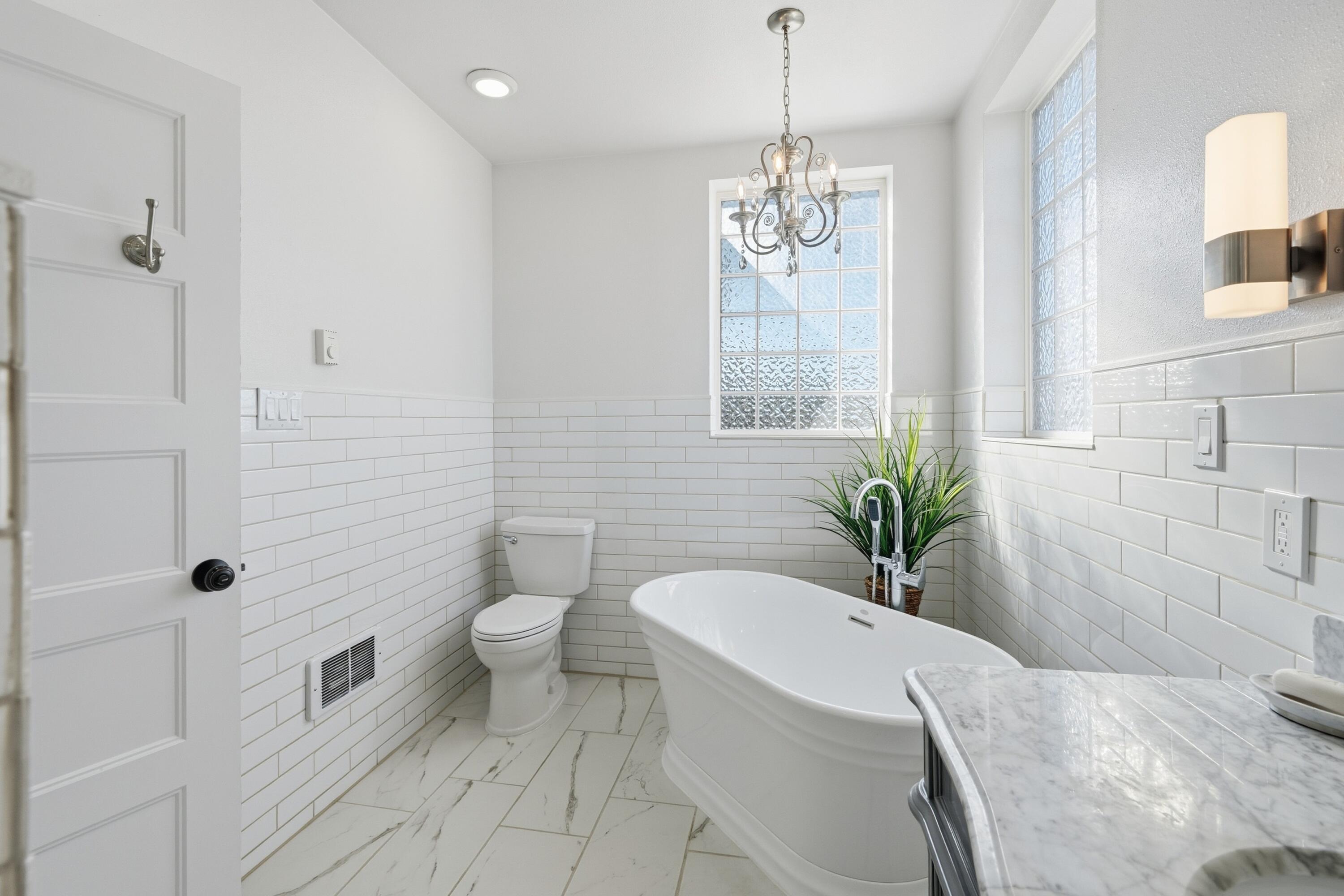 4074 Southwest Reif Road Powell Butte, OR 97753 - Photo 17 of 59 a spacious bathroom with a granite countertop sink a toilet a shower and a mirror
