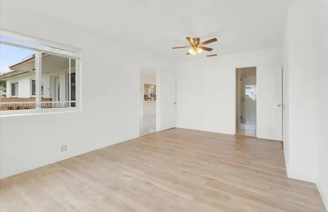a view of a big room with closet and a chandelier fan