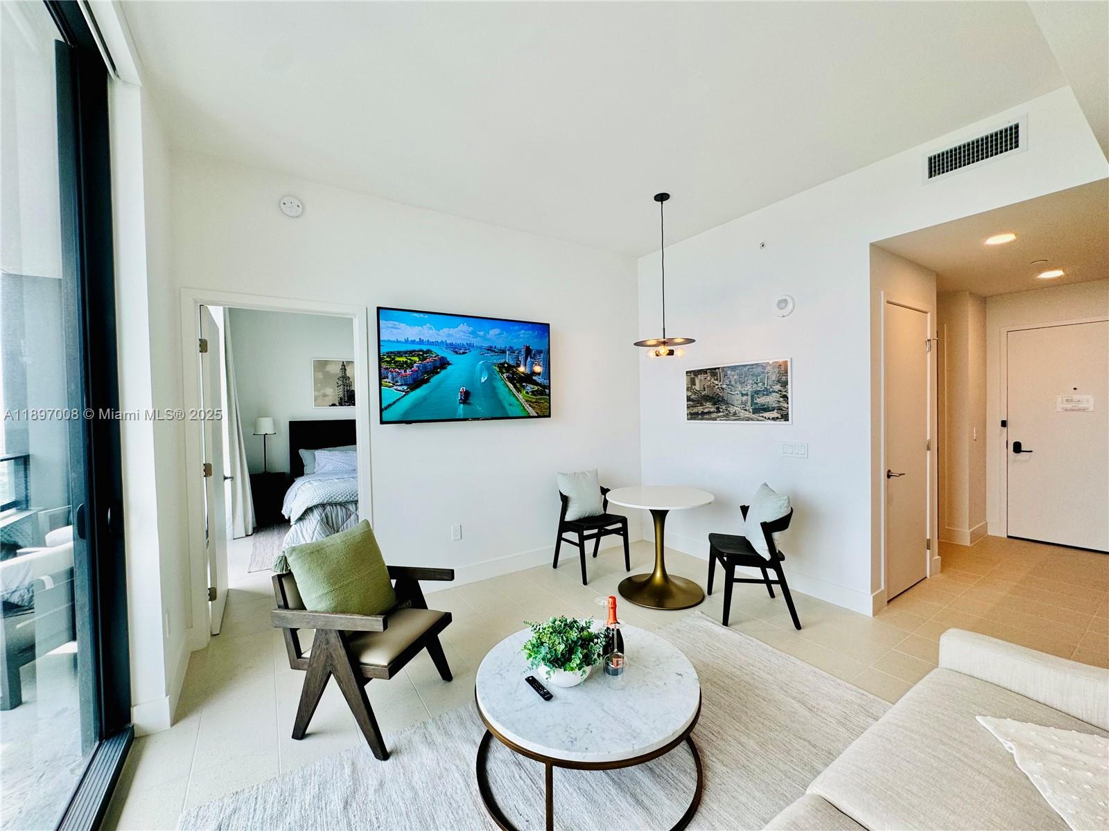 159 Northeast 6th Street, Unit 4807 Miami, FL 33132 - Photo 11 of 63 a living room with furniture and a table