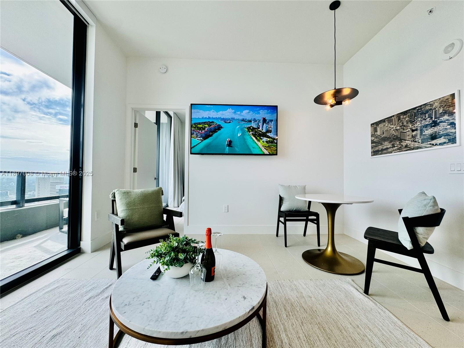 159 Northeast 6th Street, Unit 4807 Miami, FL 33132 - Photo 13 of 63 a living room with furniture and a potted plant