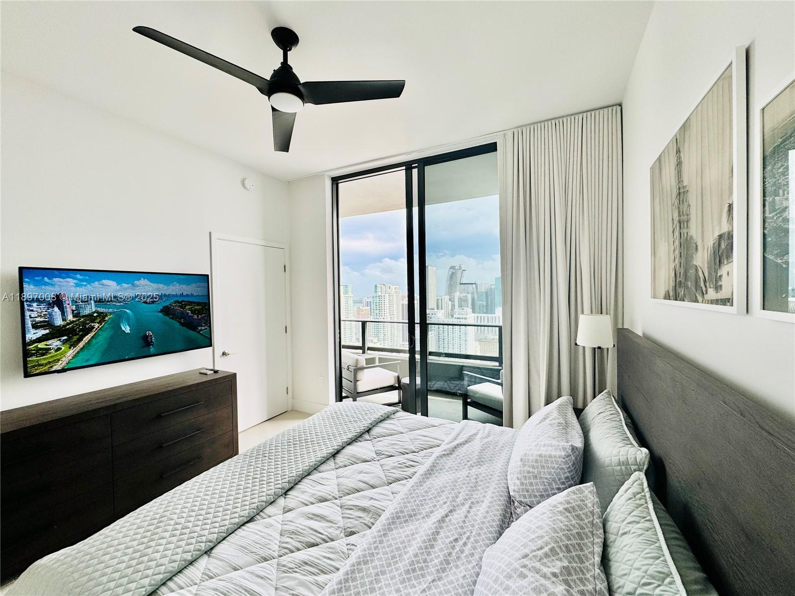 159 Northeast 6th Street, Unit 4807 Miami, FL 33132 - Photo 23 of 63 a bedroom with a large bed and a flat screen tv