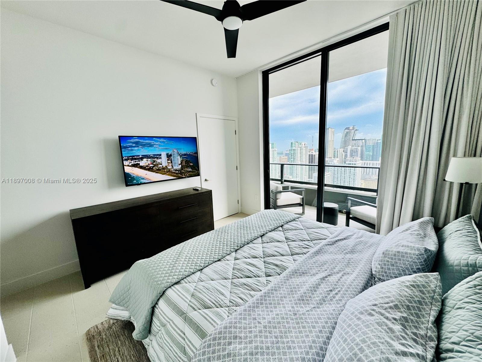 159 Northeast 6th Street, Unit 4807 Miami, FL 33132 - Photo 3 of 63 a bedroom with a bed and a painting on the wall