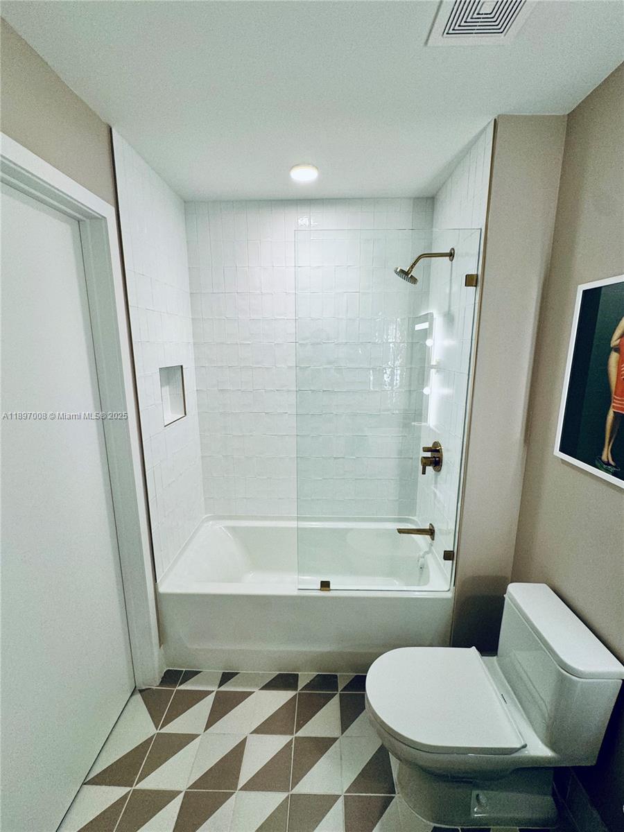 159 Northeast 6th Street, Unit 4807 Miami, FL 33132 - Photo 34 of 63 a bathroom with a toilet and a shower