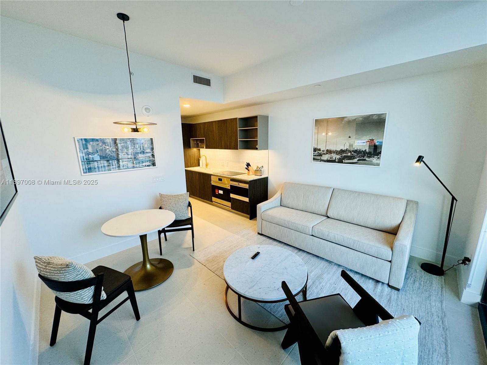 159 Northeast 6th Street, Unit 4807 Miami, FL 33132 - Photo 7 of 63 a living room with furniture and a potted plant
