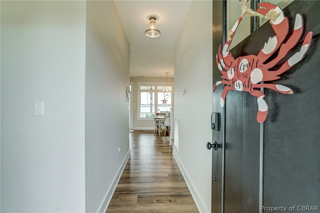 1237 Little Florida Road Farnham, VA 22460 - Photo 21 of 50 a hallway with white walls and chandelier