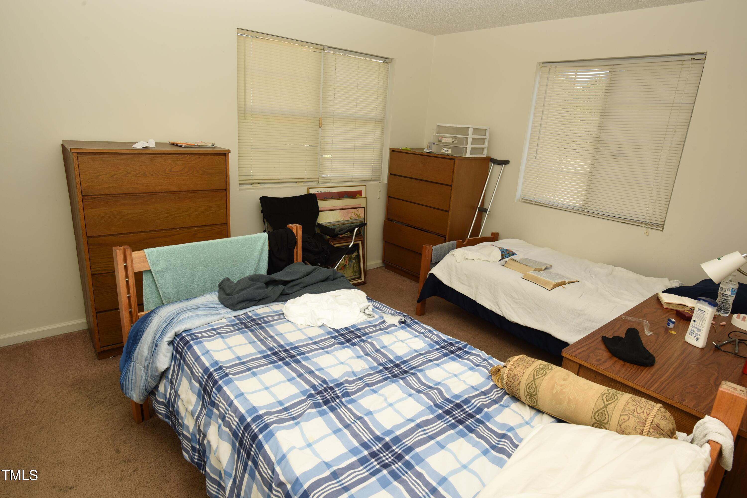 2913 Wadsworth Avenue Durham, NC 27707 - Photo 15 of 15 a bedroom with a bed and a dresser