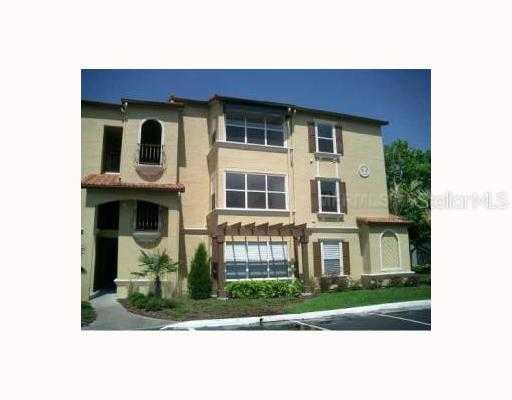 5164 Conroy Road, Unit 1537 Orlando, FL 32811 - Photo 1 of 1 a view of a house with a yard and large tree