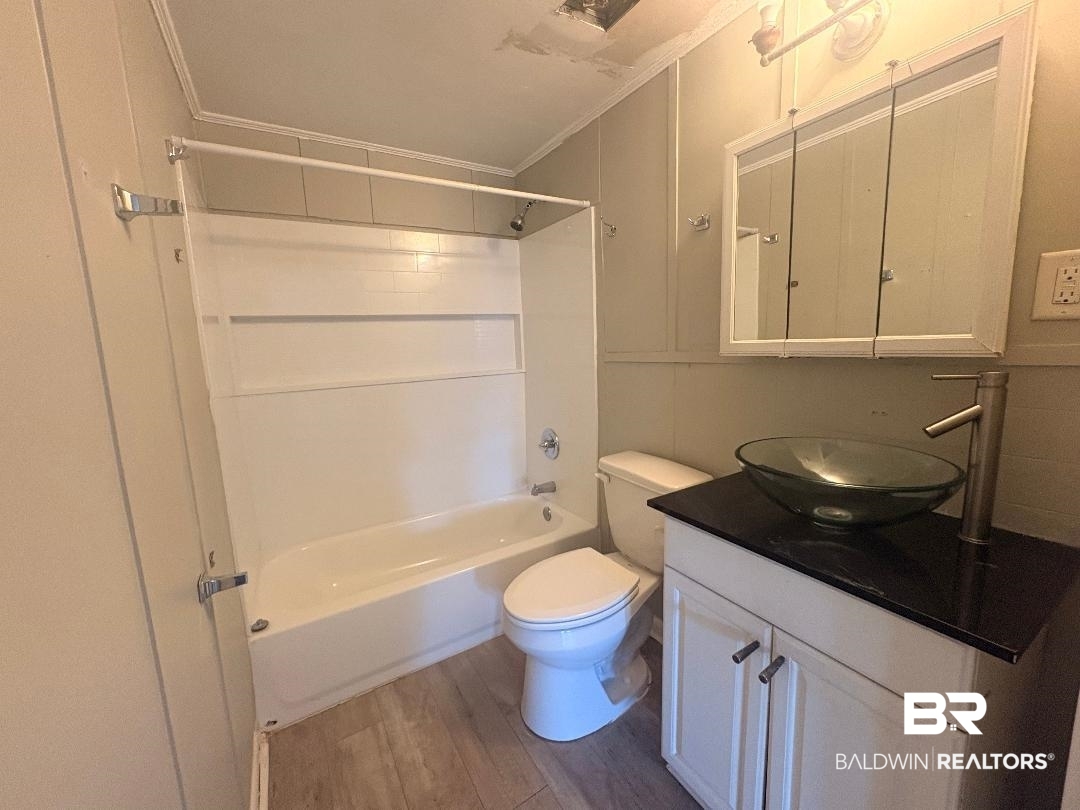 9330 Pinewood Avenue, Unit S 1 2 3 4 Elberta, AL 36530 - Photo 12 of 12 Bathroom with shower / washtub combination, vanity, ornamental molding, and light wood-type flooring