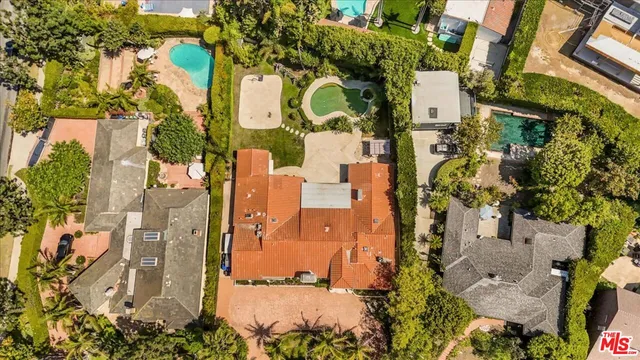 an empty room with wooden floor and natural light