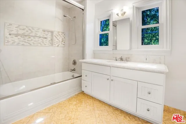 an empty room with fireplace and windows