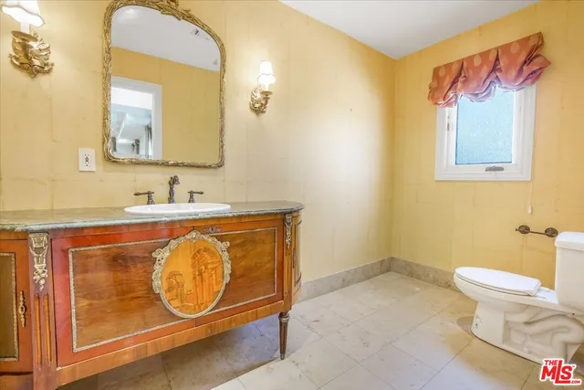 a view of walk in closet with clothes