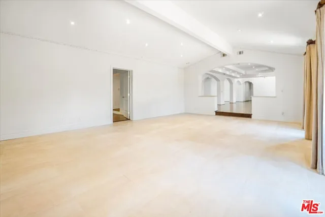 a large kitchen with stainless steel appliances granite countertop a sink stove and cabinets